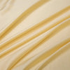Flowing light beige bamboo flat sheets draped in soft folds.