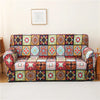 A colorful stretch floral elastic sofa cover featuring intricate geometric patterns and rich jewel tones.