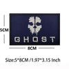 A dark blue embroidered patch featuring a white skull design and the word GHOST on a black fabric background