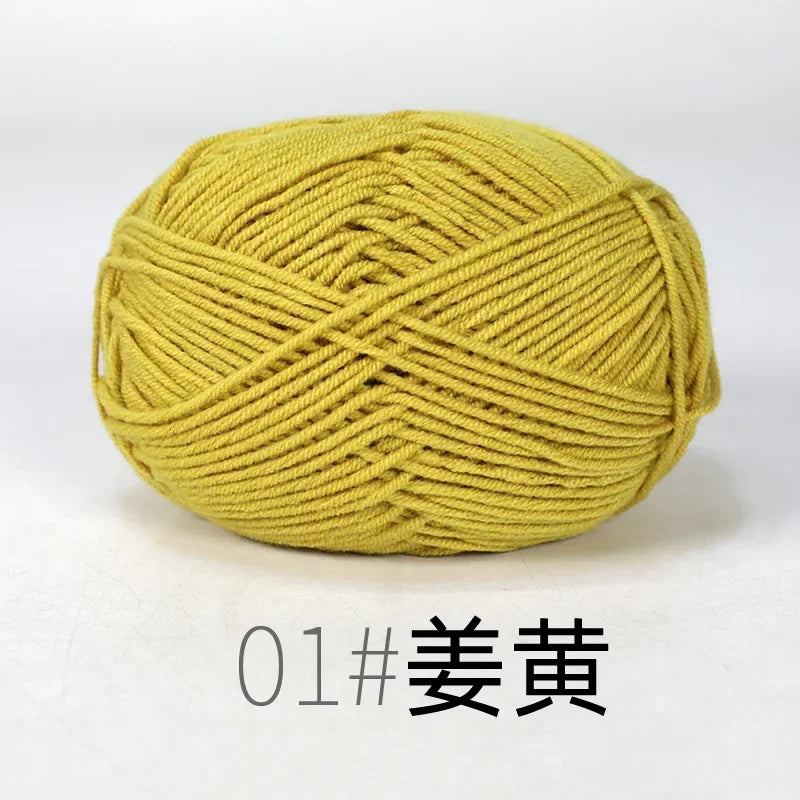 A ball of yellowish-green organic cotton 4ply knitting yarn.