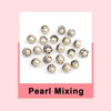 A collection of various pearl-like buttons and brooches displayed on a white background.