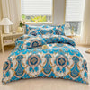 A blue and white marble print duvet cover set with pillows displayed on a bed near a window.