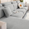 A light gray thick jacquard sofa seat cushion cover with a textured pattern and a white decorative pillow.