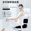 A woman is sitting in a white ergonomic chair, demonstrating the lumbar support cushion.