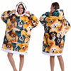 A woman models an oversized patchwork fleece hoodie featuring various dog faces in yellow, orange, and black.