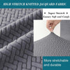 Close-up of gray high stretch knitted jacquard fabric showing a textured pattern and soft fibers.