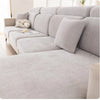 A light gray universal elastic sofa cover with a full backrest shown on a modern sofa.