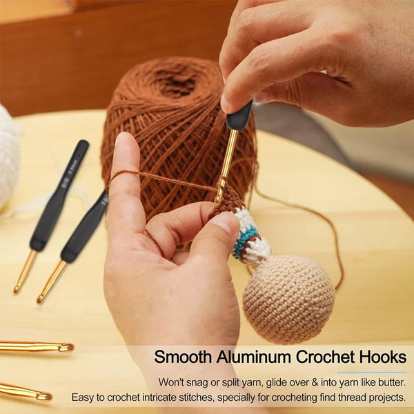 Hands are using smooth aluminum crochet hooks to work with yarn and create intricate stitches.