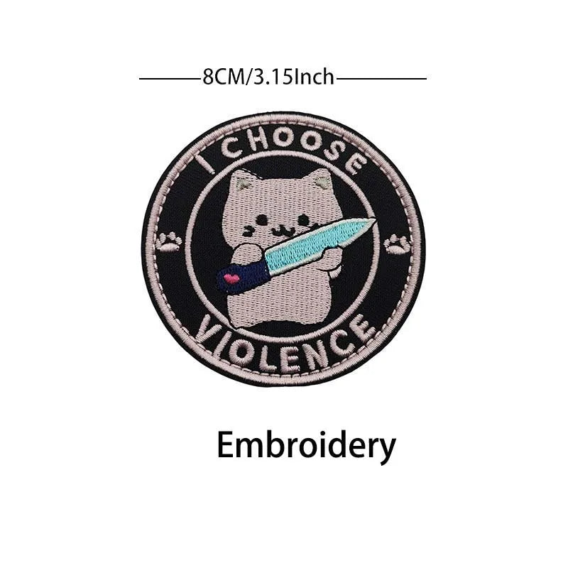 Black embroidery patch featuring a cute cat holding a knife with the word VIOLENCE around it.