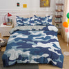 A blue and white camouflage duvet cover set displayed on a bed with surrounding decor.