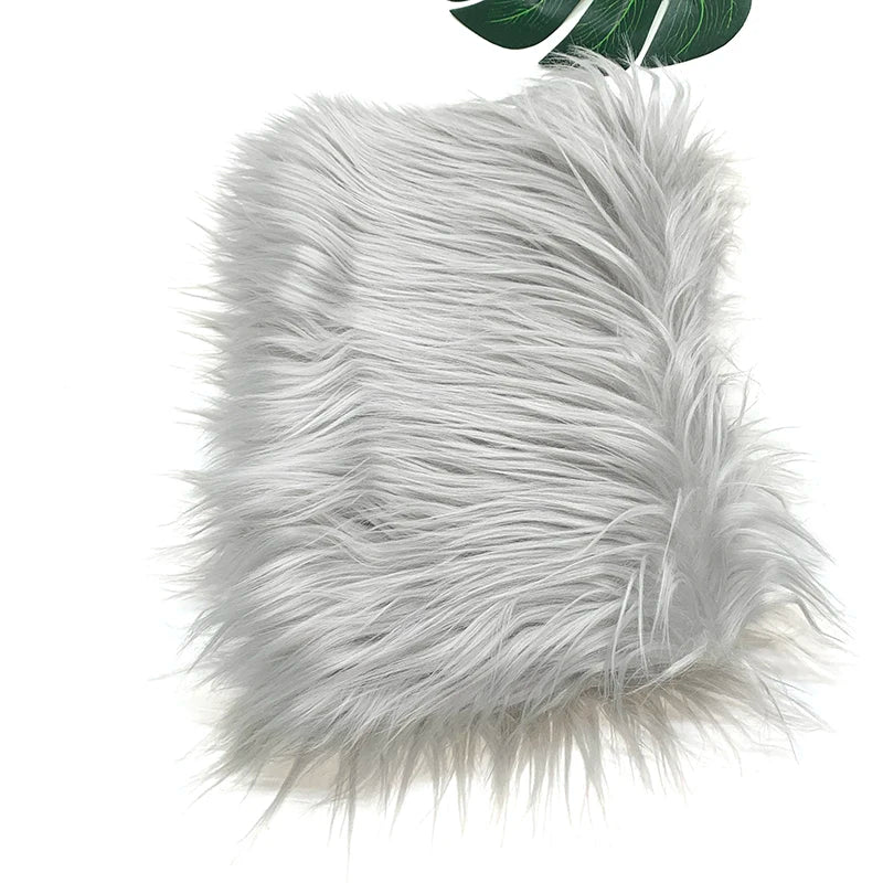 A fluffy silver gray faux fur plush fabric for sewing and crafting.
