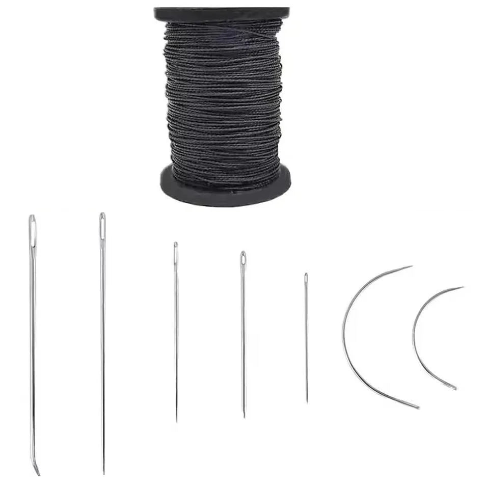 A spool of black waxed thread and various leather sewing kit components including needles and rings.