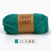 A skein of teal green hand-dyed fabric strip yarn labeled Sweet Candy Yarns.