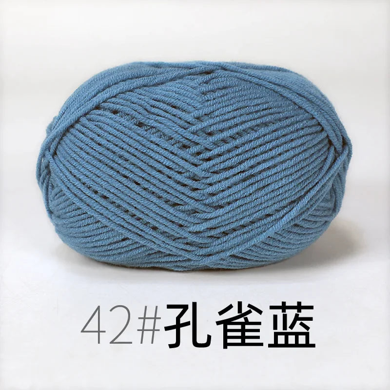 A ball of light blue knitting yarn labeled 42# 孔雀蓝
