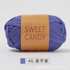 A ball of purple hand-dyed fabric strip yarn labeled SWEET CANDY