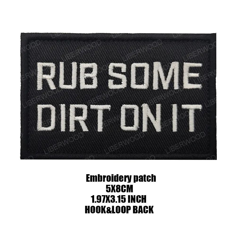 Black embroidered patch with white text that reads RUB SOME DIRT ON IT