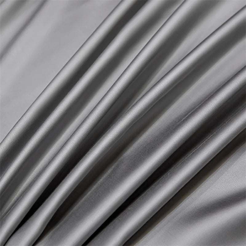 Gray luxury bamboo flat sheets draped and folded, showing soft texture and drape.
