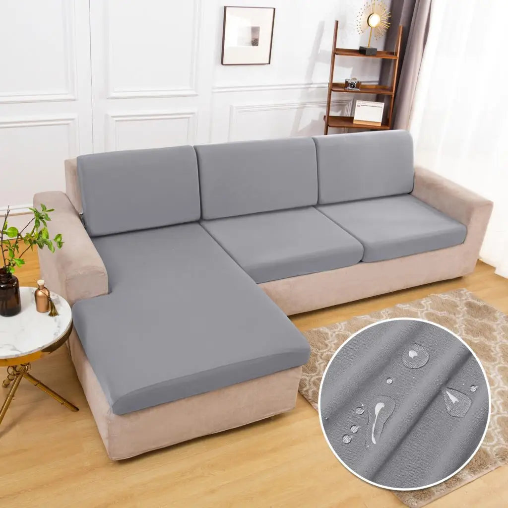 A light gray waterproof sofa cushion protector cover is shown on a beige sofa.