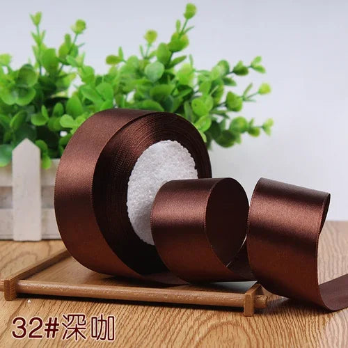 Roll of 4 cm wide satin ribbon in a brown color for gift wrapping and DIY crafts