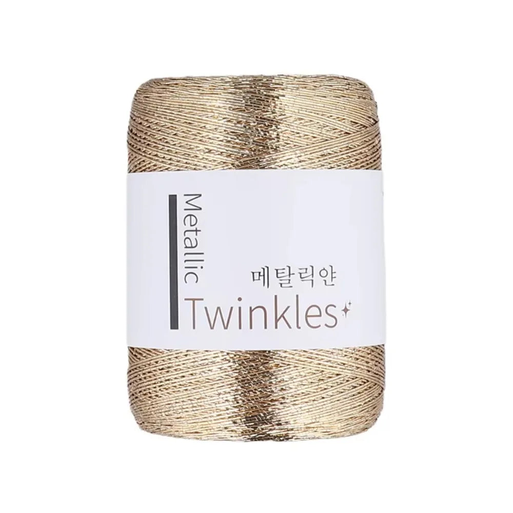 Spool of metallic gold twine or yarn labeled Twinkles for crafting