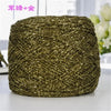 A ball of metallic gold silk yarn used for crocheting and knitting.