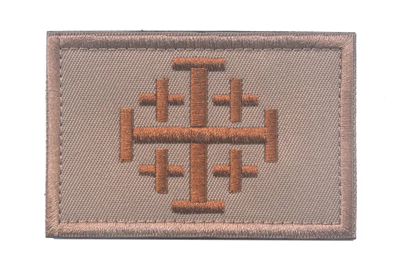 A rectangular embroidered military cross shield patch in tan color with a hook and loop backing.