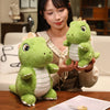A woman holds a cute green dinosaur plush toy with white stripes on her hands.