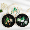 Two circular embroidery hoops display floral cross stitch designs on white and black fabric.