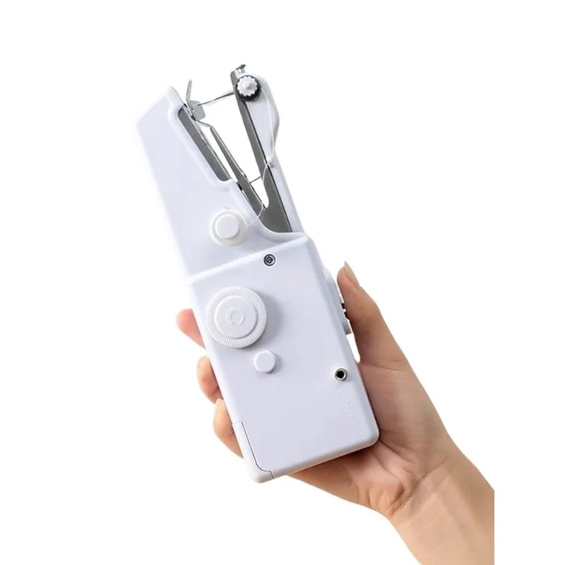 A hand holding a white portable mini hand sewing machine with metal sewing tools.