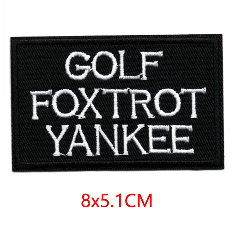 Black embroidered patch with white text reading GOLF FOXTROT YANKEE