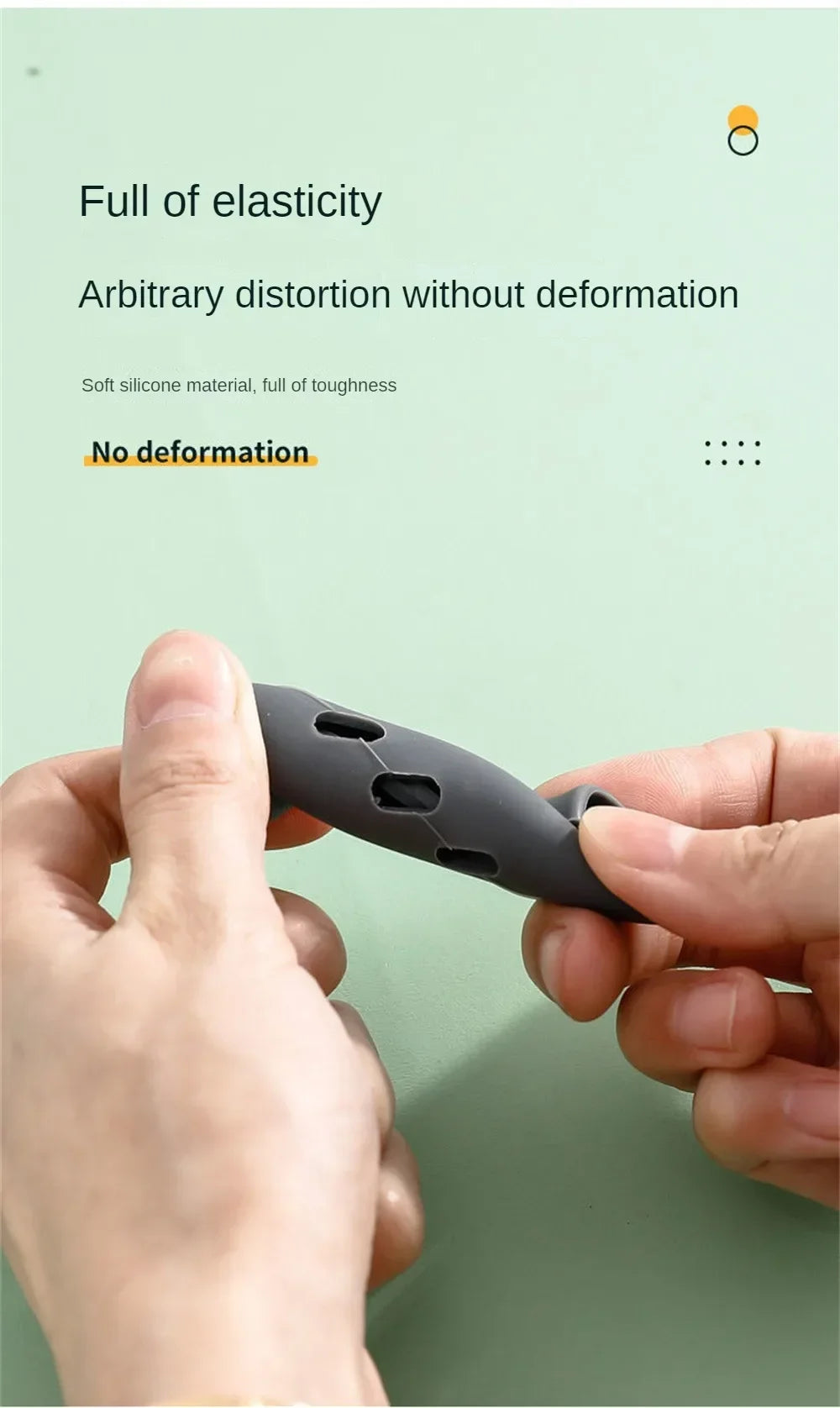A hand holds a dark silicone pan handle cover, demonstrating its elasticity and ability to withstand distortion.
