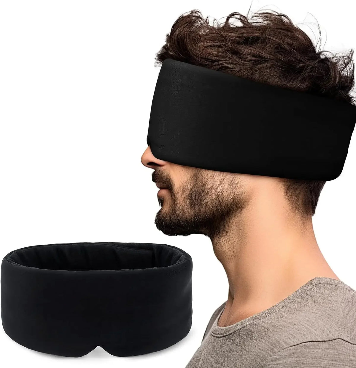 A man wearing a black 3D contoured travel sleep mask with a neck pillow for eye pressure relief.