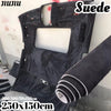Black suede auto headliner fabric roll with foam backing shown against a white wall.