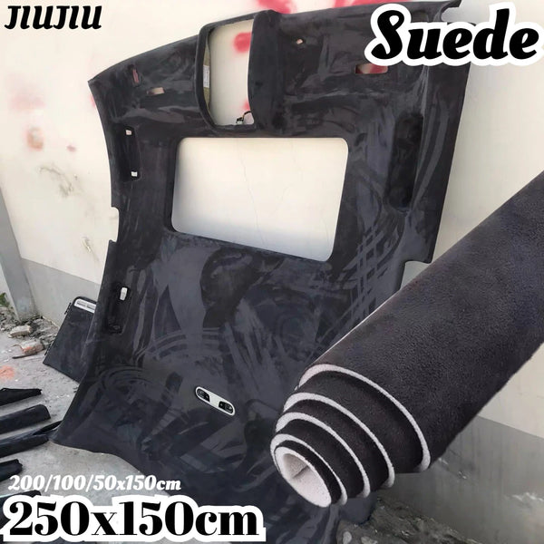 Black suede auto headliner fabric roll with foam backing shown against a white wall.