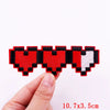 A set of colorful embroidered heart letter patches in red, black, and white on a white background.