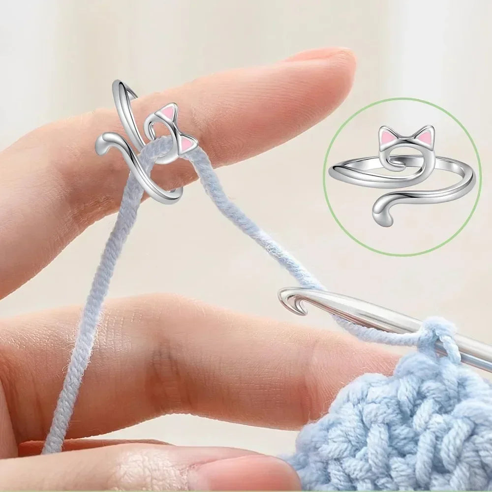 A hand is shown using a pair of pliers to attach an adjustable crochet tension ring to a knitted item.