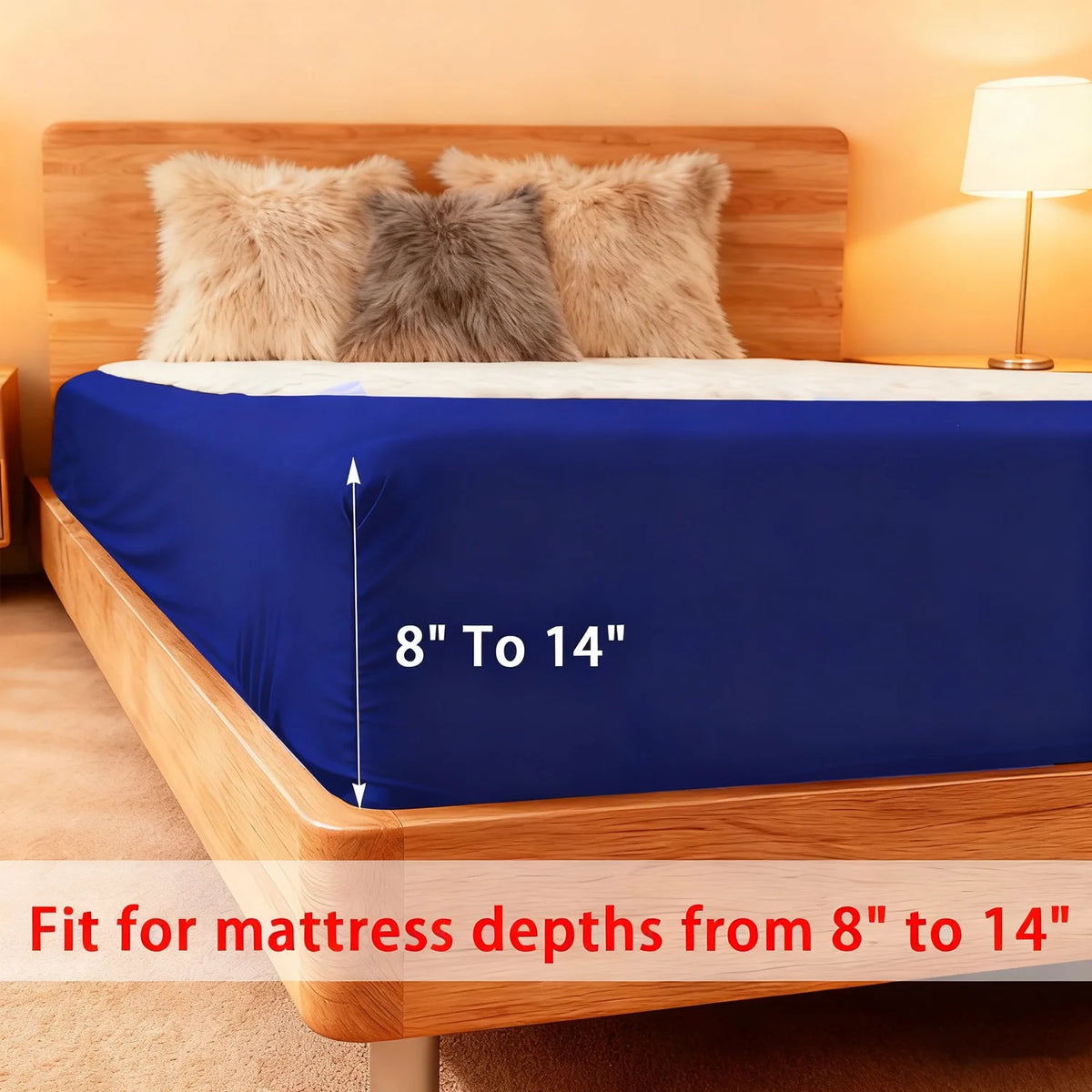 A blue box spring cover is shown on a wooden bed frame with fluffy pillows, suitable for mattresses 8 to 14 inches deep.