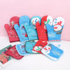 A collection of festive Christmas insulated oven mitts in red, blue, and green featuring Santa and snowman designs.