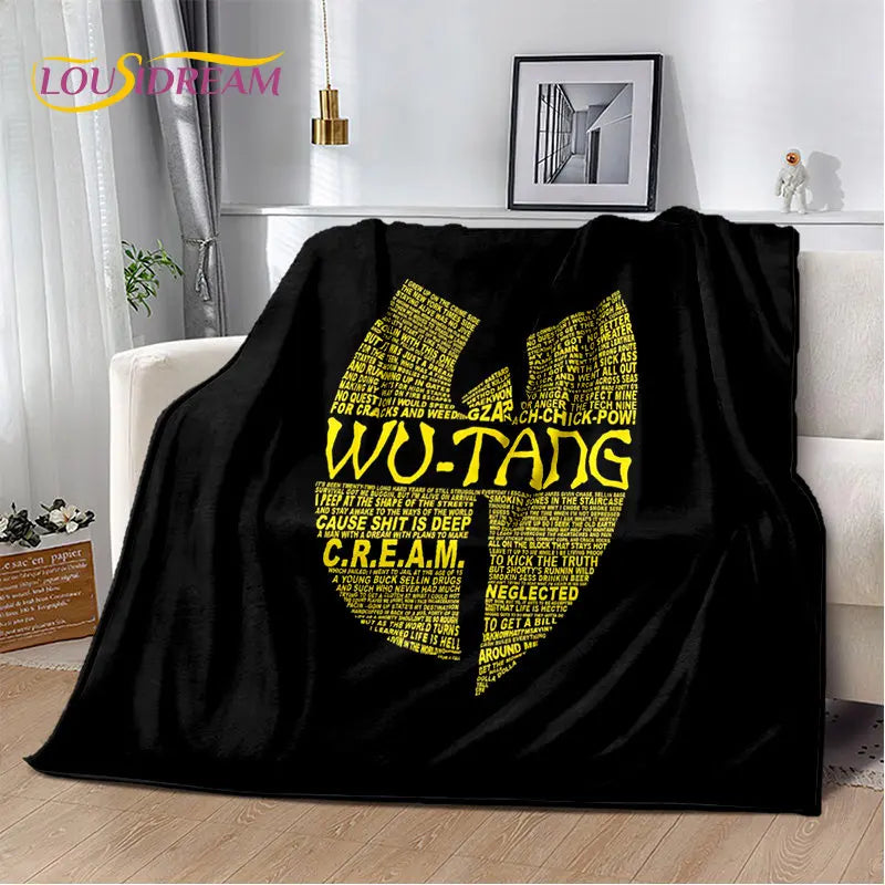 A black flannel throw blanket featuring yellow text with the phrase WU-TANG on it.