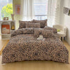 A leopard print duvet cover set with matching pillowcases displayed on a bed in a bright room.