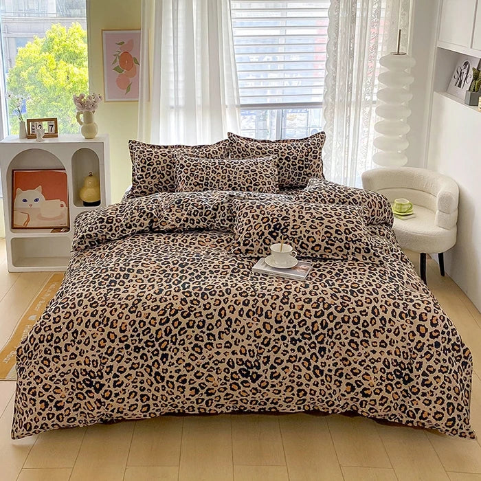 A leopard print duvet cover set with matching pillowcases displayed on a bed in a bright room.