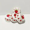 A display of white oil-proof baking cups decorated with red strawberry patterns.