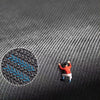 A small, orange, leaf-shaped rubber mat is placed on a dark gray textured surface.