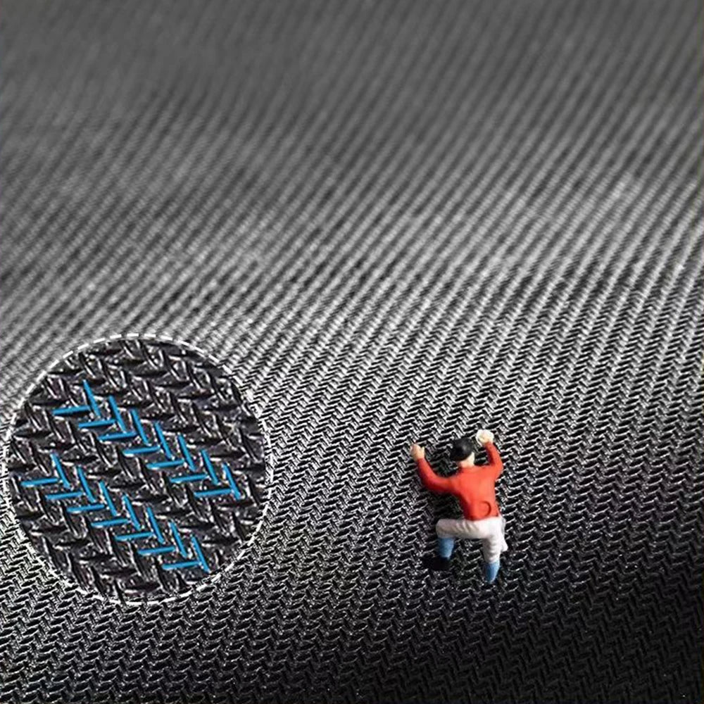 A small, orange, leaf-shaped rubber mat is placed on a dark gray textured surface.