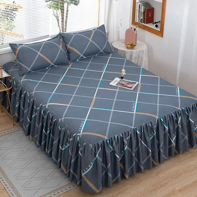 A set of three gray fitted bed sheets with an orange and white geometric pattern and elastic lace trim.