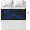 A black conductive grounding mattress pad is shown resting on a white bed, with a white cord connected to it.