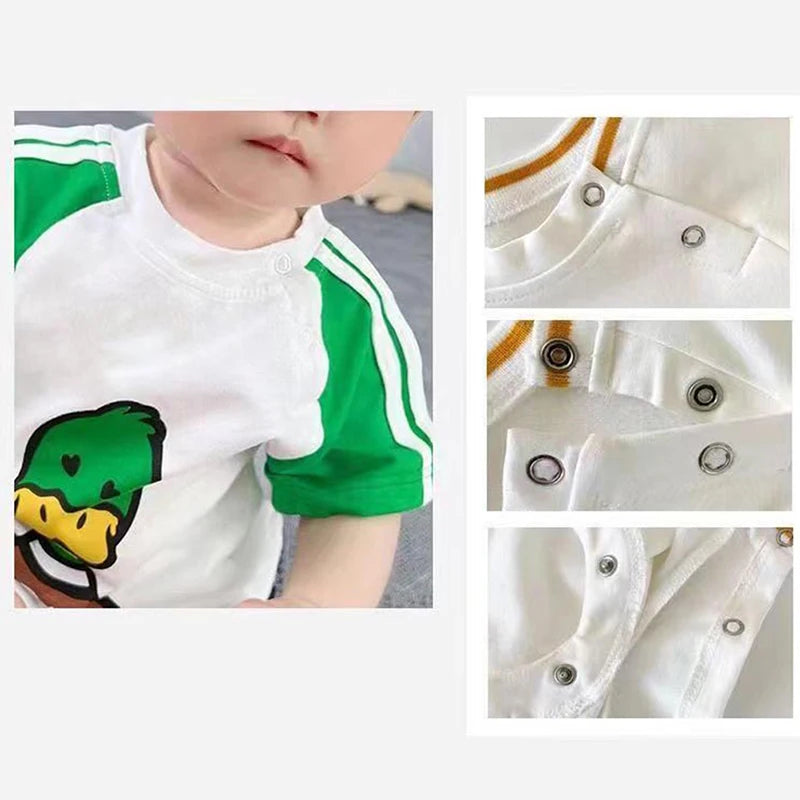 White and green short-sleeved shirt with a graphic design and snap buttons shown in detail.