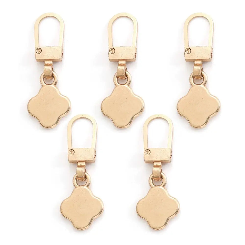 A set of five gold-toned metal zipper pull replacement kits with oval loops and square charms.