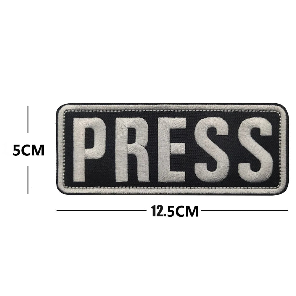 Black and white embroidered press armband patch with hook and loop backing
