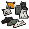 A collection of embroidered patches featuring various animal faces and meme expressions in orange, gray, black, and white.